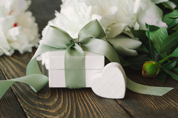 istock Bouquet of beautiful white peonies with gift boxes 1496914038