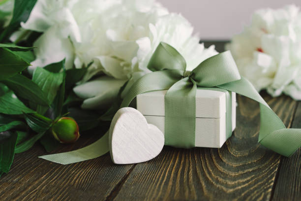 istock Bouquet of beautiful white peonies with gift boxes 1496914039