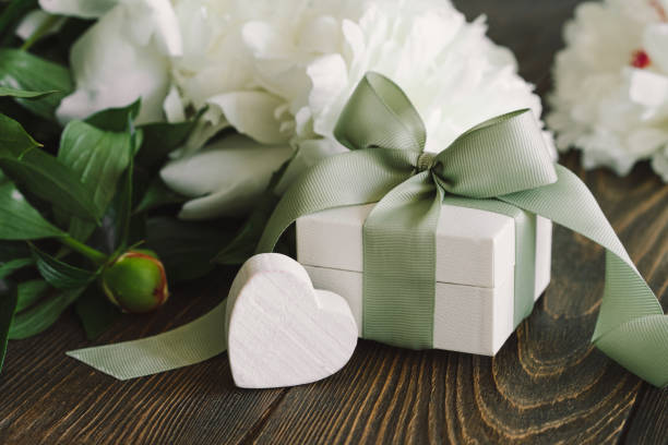 istock Bouquet of beautiful white peonies with gift boxes 1496914040