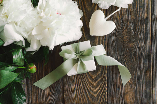 istock Bouquet of beautiful white peonies with gift boxes 1496914070