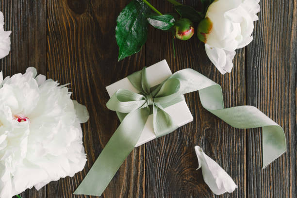 istock Bouquet of beautiful white peonies with gift boxes 1496914142