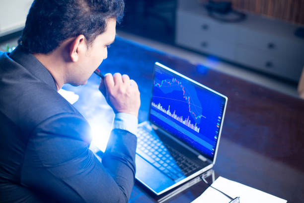 Businessman or stock market trader working on laptop screen, Financial market trading, Candlestick chart graphic , Crypto and forex market. Businessman or stock market trader working on laptop screen, Financial market trading, Candlestick chart graphic , Crypto and forex market. shareholders meeting stock pictures, royalty-free photos & images