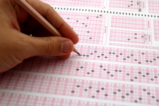 istock Exam, a hand taking a test with a pencil over an optical reader. Future Anxiety. Uncertainty. 1496919570