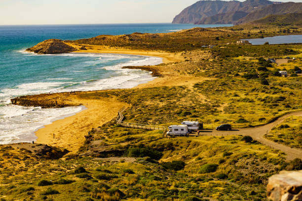 istock Coast view with camper rv camping on sea shore, Spain 1496919950