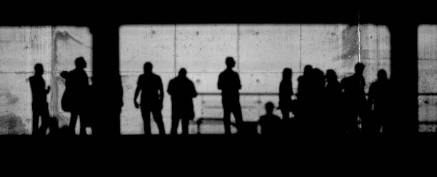 istock shadows of people waiting at the train station 1496920358