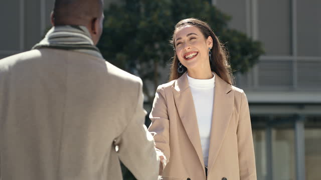 Business people, handshake and meeting in city for deal agreement, b2b or partnership outdoors. Happy businessman and woman shaking hands for introduction, greeting or welcome outside an urban town