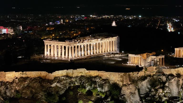 Closeup aerial night view of the illuminated Parthenon Temple at the Acropolis of Athens