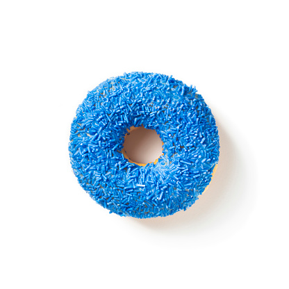 Sweet donut in colored blue glaze on a white background top view