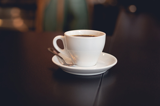 cup of coffee indoors at the table