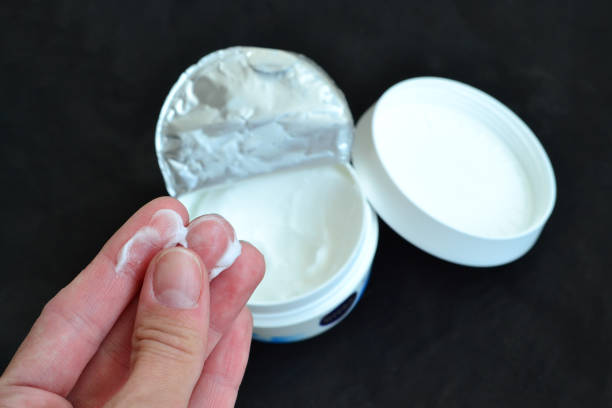 The girl lubricates her hands with cream