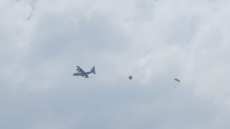 Paratroopers jumping of plane in during a military training exercise.