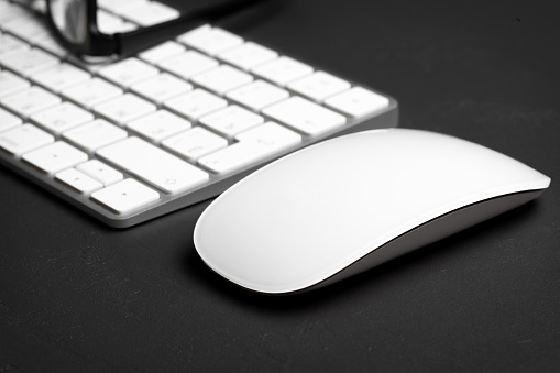 Closeup of keyboard and mouse on gray background