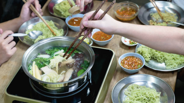 istock party eating sukiyaki in home 1496934107