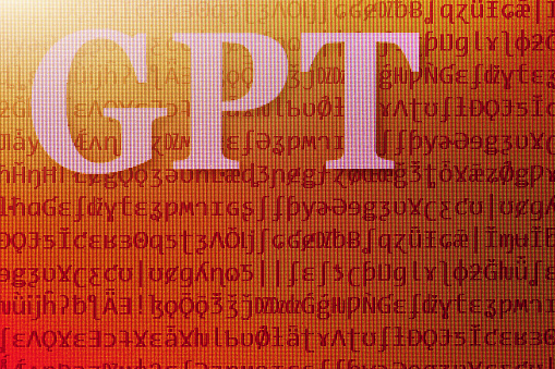 Photograph of a computer screen displaying the abbreviation GPT. The backdrop of meaningless special characters symbolizes the \
