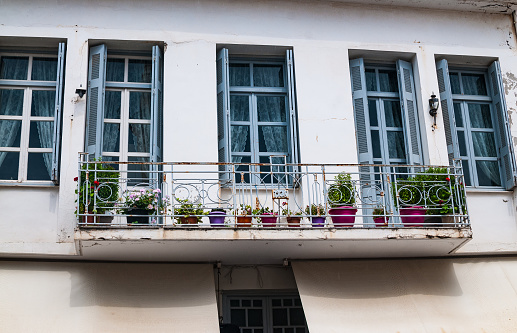 Balcony with flower pots on the facade of an old house