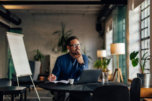 istock Thougtful businessman looking on the side, working over the laptop. 1496935342