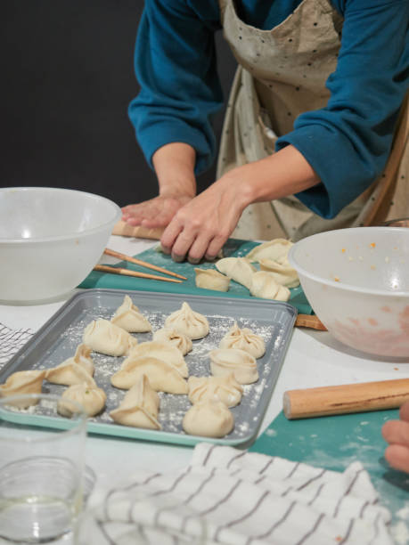 istock woman making traditional dim sum Chinese dumplings, stuffed dough 1496936996