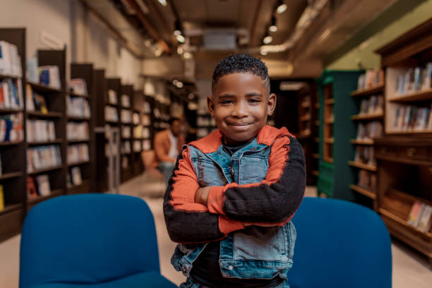 istock Portrait of a young school child black reader in a library 1496939630