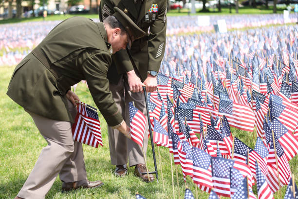 Military Officers Planting U.S. Flags Military officer planting U.S, flags on Boston Common during Memorial Day ceremony in Boston, U.S. May 25, 2023. proud army mom stock pictures, royalty-free photos & images