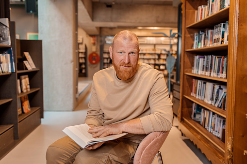 Portrait of an adult reader in a library