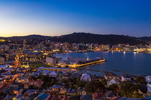 An aerial view over Wellington's downtown district, harbour and marina after sunset.