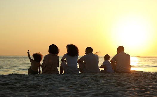 Peace, sunset and travel with big family on beach for vacation, support and happiness. Bonding, summer break and holiday trip with parents and children at coast for care, generations or nature mockup