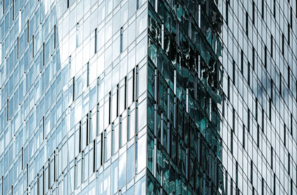 Modern office exterior facade close-up reflecting buildings and environment and forming unique complex pattern