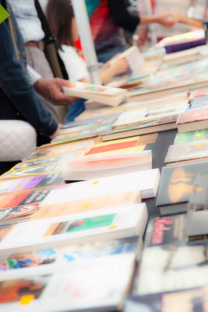 istock Buying books at a street stall. 1496945819