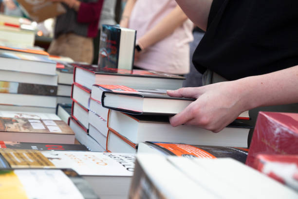 istock Buying books at a street stall. 1496945824