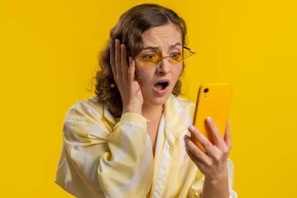 istock Woman use smartphone typing browsing loses becoming surprised sudden lottery result bad fortune 1496947456