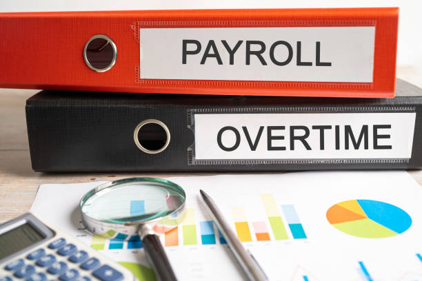 istock Payroll overtime. Binder data finance report business with graph analysis in office. 1496947960