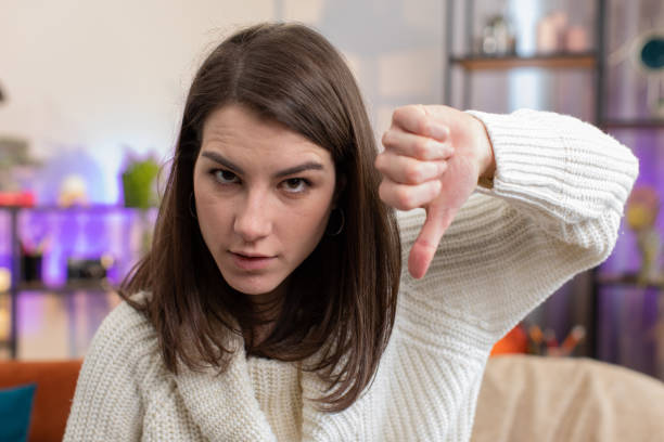 istock Upset young woman showing thumbs down, dislike bad work, disapproval, dissatisfied feedback at home 1496948598