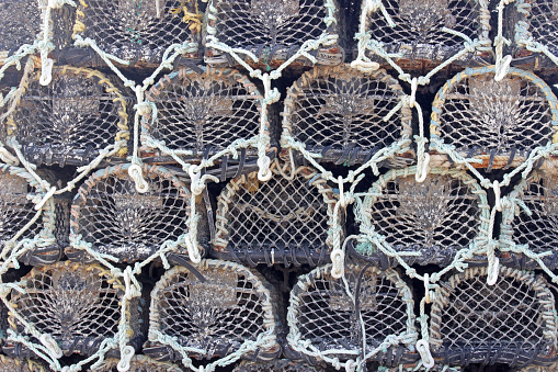 Crab cages or lobster pots stacked up creates a nautical background pattern