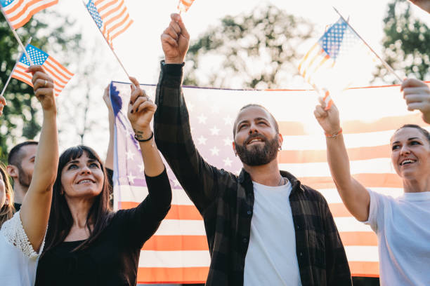 istock A group of people is waving small American flags at sunset 1496951739
