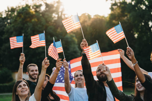 istock A group of people is waving small American flags at sunset 1496951765