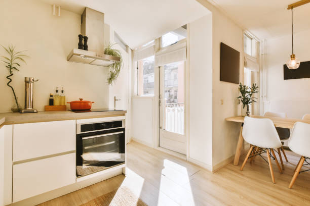 istock a kitchen with a stove and a table and chairs 1496951905