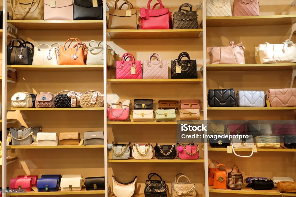 Colorful group of female hand bags Close up female hand bags in retail store Purse Stock Photo
