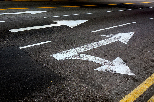 Close up arrow signs on asphalt city road
