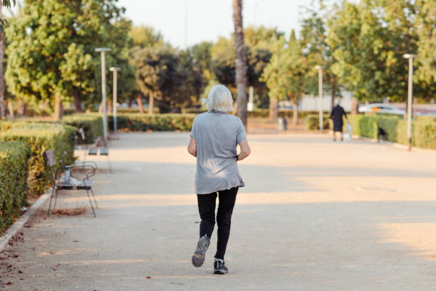 istock older woman running in a park with her back to the camera 1496953813