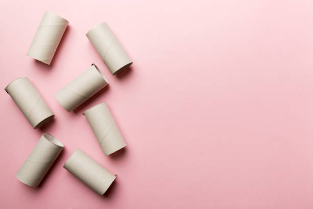 istock Flat lay composition with empty toilet paper rolls and space for text on color background. Recyclable paper tube with metal plug end made of kraft paper or cardboard 1496954197