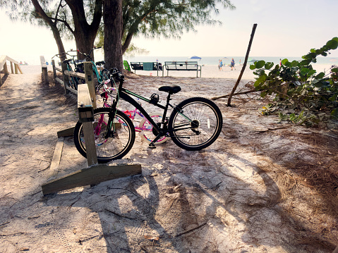 Parked bicycles on tropical beach of Anna Maria Island, Florida