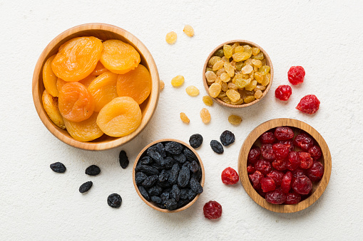 Bowl with different dried fruits on table background, top view. Healthy lifestyle with copy space.