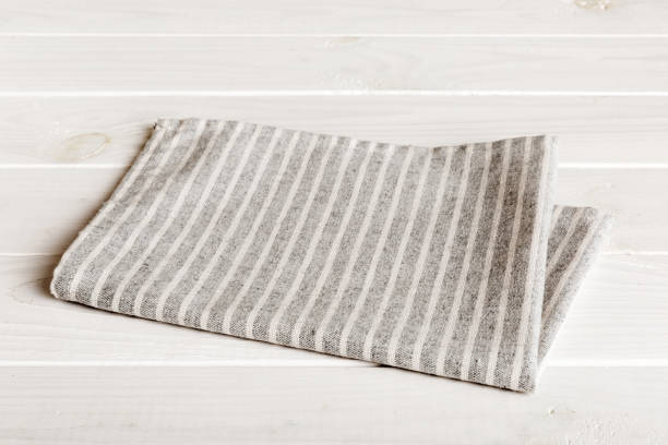 istock top view with gray kitchen napkin isolated on table background. Folded cloth for mockup with copy space, Flat lay. Minimal style 1496954320