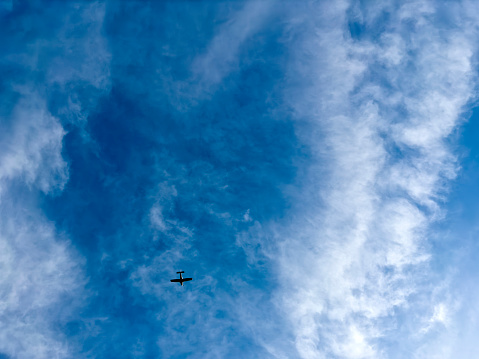 Propeller airplane in cloudy sky