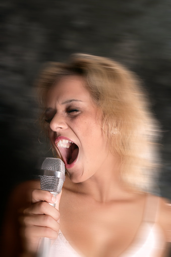 Close up portrait of woman holding microphone