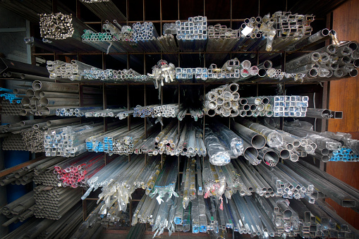 Industrial steel products of metal profiles and tubes on warehouse shelf