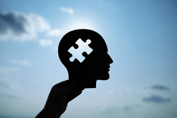 istock Concept of a human head with a puzzle in the middle 1496960707