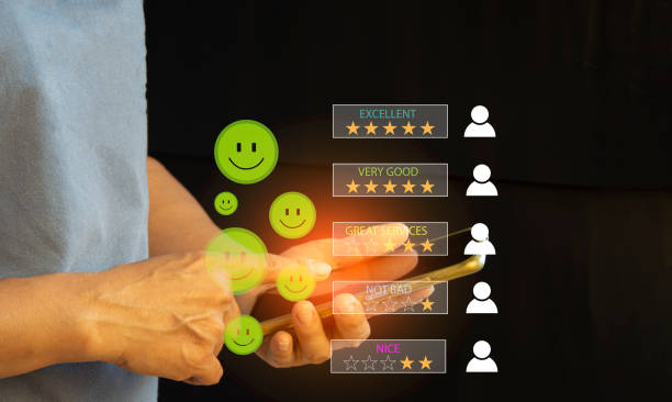 istock close up Man hand using smartphone with popup five star icon for feedback review satisfaction service, Customer service experience and business satisfaction survey. 1496961388