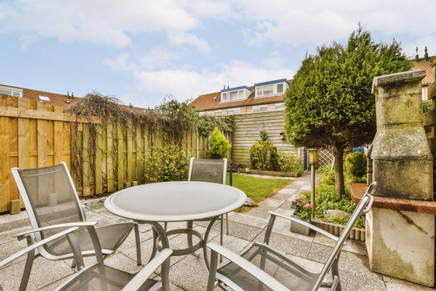istock a patio with a table and chairs and a garden 1496963214