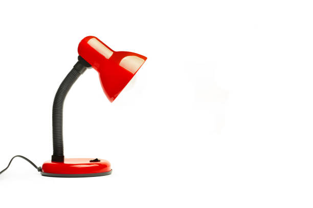 istock A black and red desk lamp on a white background with copy space 1496963364